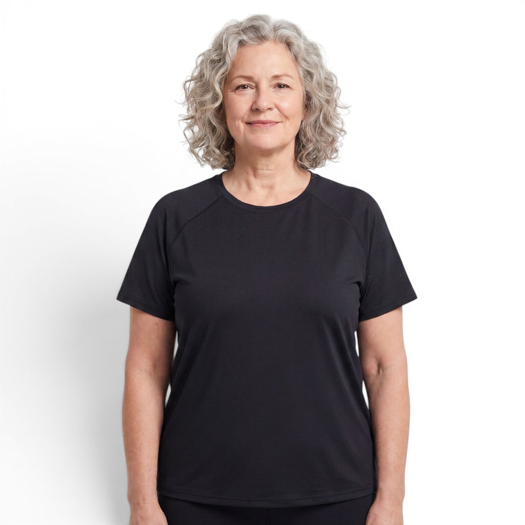Mature woman wearing a black OUTDOORS NORDIC quick-dry stretch t-shirt with a cooling ice-silk feel.