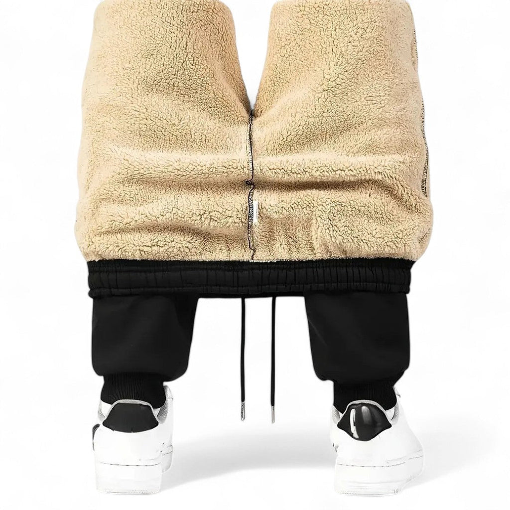 OUTDOORS NORDIC Fleece 24/7 Pants featuring a thick beige sherpa fleece lining and black elasticated cuffs.
