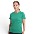 A woman wearing an OUTDOORS NORDIC green quick-dry stretch t-shirt with a smooth, cooling ice-silk texture.