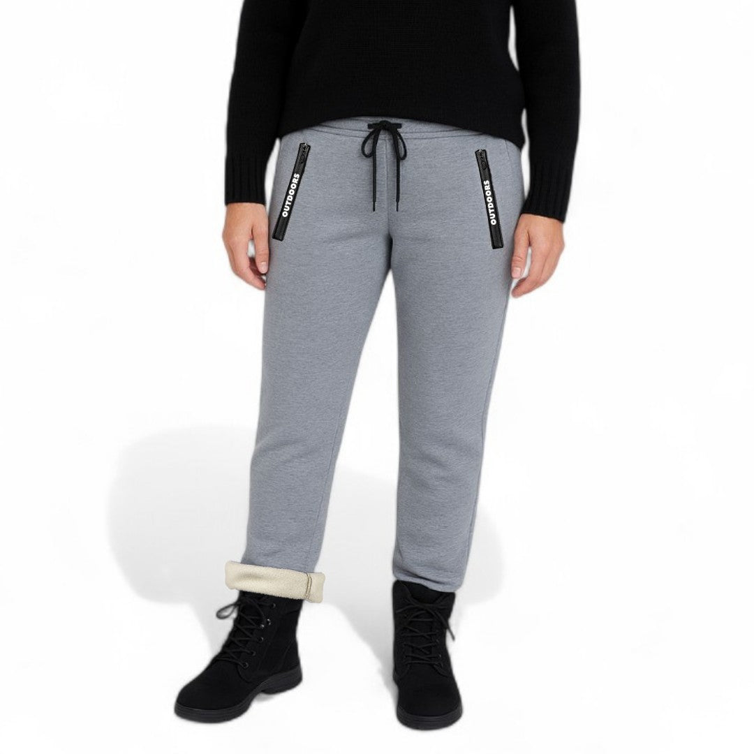 OUTDOORS NORDIC grey fleece-lined sweatpants with zippered pockets and adjustable drawstring waist on a person.