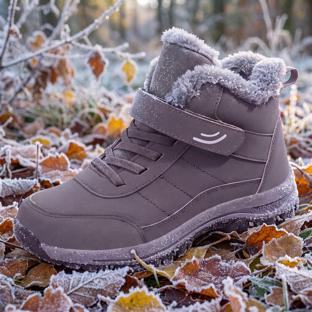 OUTDOORS NORDIC grey winter boots with plush lining, velcro strap, and non-slip sole on frosty autumn leaves.