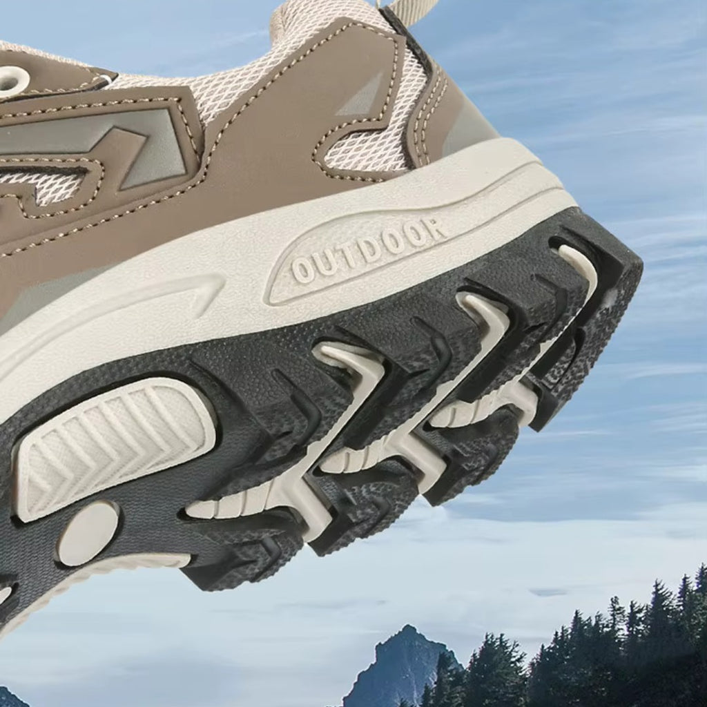 OUTDOORS NORDIC low ortho hiking shoe featuring a beige mesh upper and a rugged black TPU grip sole for outdoor trails.