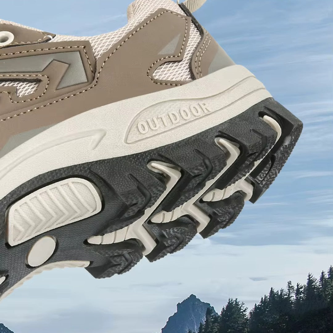 OUTDOORS NORDIC low ortho hiking shoe featuring a beige mesh upper and a rugged black TPU grip sole for outdoor trails.