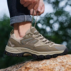OUTDOORS NORDIC low-top hiking shoes in khaki mesh and synthetic material with a rugged TPU sole on a rocky surface.
