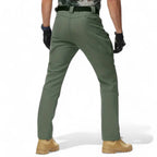 OUTDOORS NORDIC olive green utility fleece pants with multiple pockets, worn by a man in a back view.