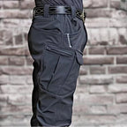 OUTDOORS NORDIC utility fleece pants in dark grey with multiple cargo pockets and a durable, windproof stretch fabric.