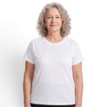 A woman with curly grey hair wearing a white OUTDOORS NORDIC quick-dry stretch t-shirt with a smooth, cooling texture.