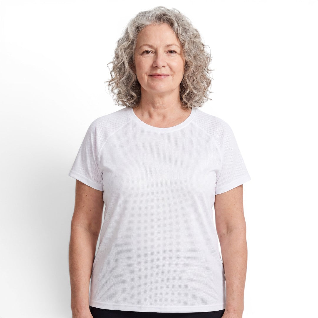 A woman with curly grey hair wearing a white OUTDOORS NORDIC quick-dry stretch t-shirt with a smooth, cooling texture.